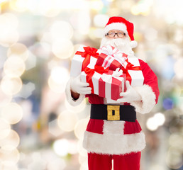 man in costume of santa claus with gift boxes
