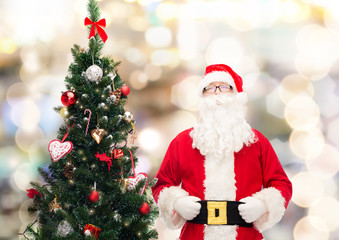 man in costume of santa claus with christmas tree