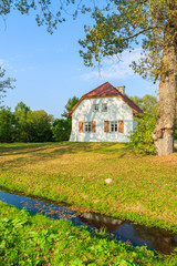 Plakat Traditional cottage house in countryside landscape of Poland