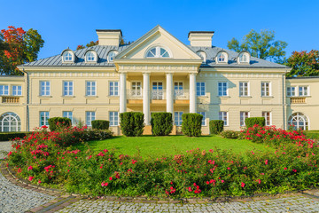 Red roses in park of beautiful palace in Smilowice, Poland