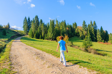 Young woman tourist on path in Pieniny Mountains. Poland