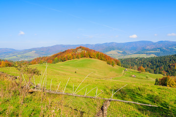 Fence on green field on in autumn day,Pieniny Mountains, Poland