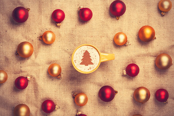 cappuccino with christmas tree shape and with red and gold chris