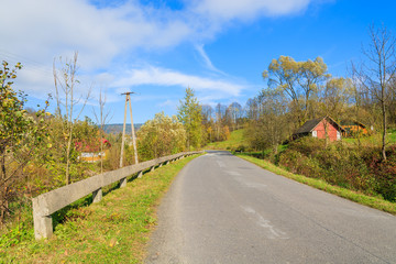 Countryside road in autumn landscape, Beskid Niski Mountains - obrazy, fototapety, plakaty