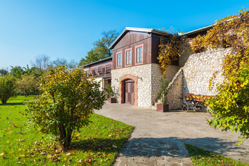 Fototapeta na wymiar Traditional house in Tomaszowice village park in autumn, Poland