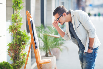 Young tourist reading menu displayed on the street