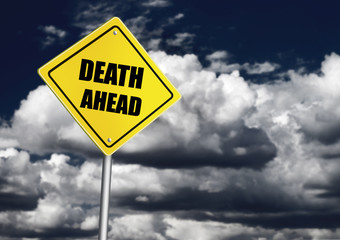 Death ahead sign over cloudy sky