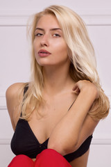 Hot blonde girl posing in white room