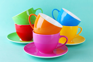 Colorful cups on color background