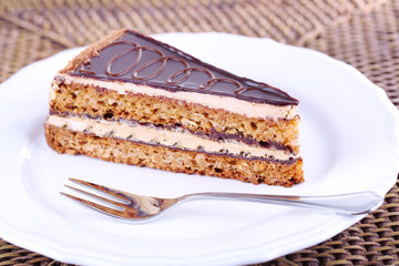 Delicious chocolate cake on plate on table close-up