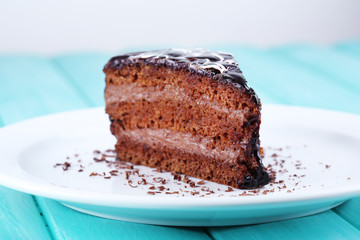 Delicious chocolate cake on plate on table close-up