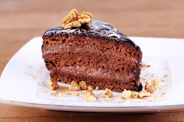 Delicious chocolate cake on plate on table close-up