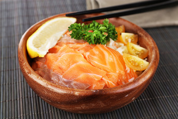 Bowl of boiled rice and fresh salted salmon