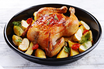 Delicious baked chicken on table close-up