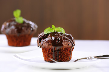 Yummy chocolate cupcake on table