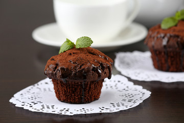Yummy chocolate cupcake on table
