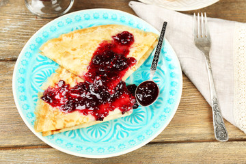 Plate of delicious pancakes with berry jam