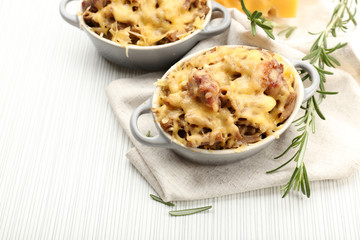 Pasta baked with vegetables and cheese in ceramic pot