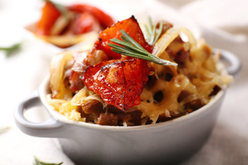 Pasta baked with vegetables and cheese in ceramic pot
