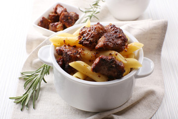 Tasty pasta with meat in ceramic pot