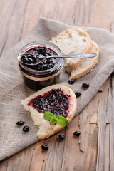 Delicious black currant jam on table close-up