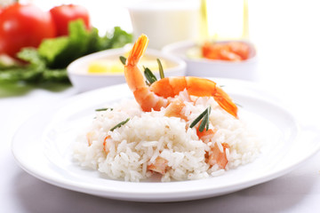 Boiled rice with shrimps served on table, close-up