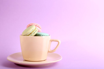 Assortment of gentle colorful macaroons in colorful mug