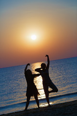 Girls dancing at sunset