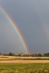 Double Rainbow in Village Landscape