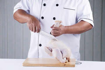 Chef prepared chopping raw chicken