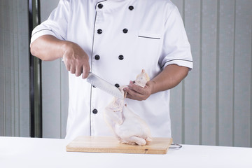 Chef prepared chopping raw chicken