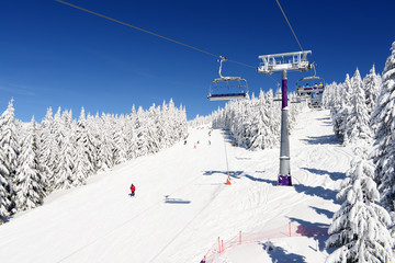 Fototapeta na wymiar A skier coming down the mountain slope