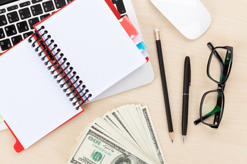 Office table with pc, supplies and money cash