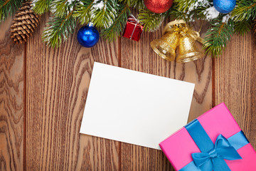 Fototapeta na wymiar Christmas gift box and blank photo frame over wooden background
