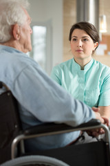 Fototapeta premium Disabled man talking with nurse