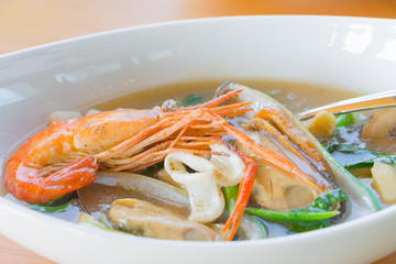 Wide rice noodles in gravy with seafood