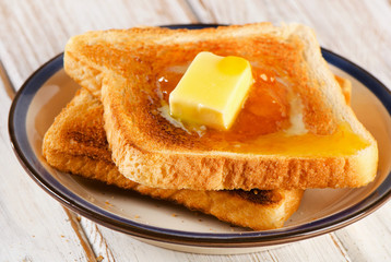 Two Slices toast bread ona  wooden background.