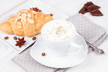 Coffee cup and croissant