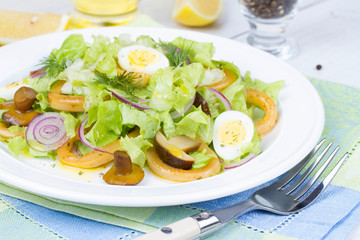 Fresh salad with mushrooms, squid and quail eggs