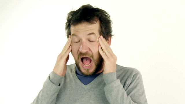 Man feeling head exploding for migraine