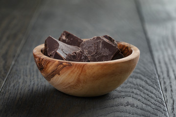 dark chocolate chunks in wooden bowl