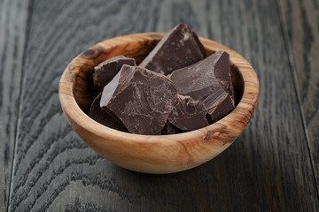 dark chocolate chunks in wooden bowl