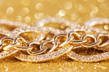 close up of gold chainlet. luxe golden glitter background