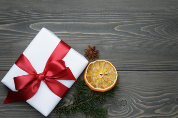 gift box with red bow on wood table
