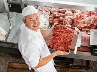 Confident Butcher Holding Minced Meat