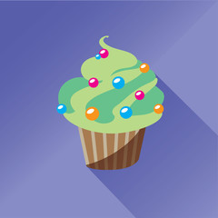 Green cupcake decorated with sugar balls