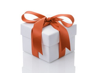 white gift box with orange ribbon bow