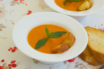 Light lunch soup-tomato soup with croutons in white plate
