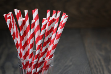 vintage paper straws in glass on wood table