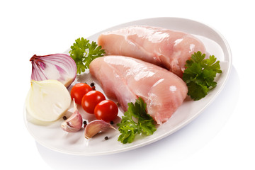 Raw chicken fillets on white background